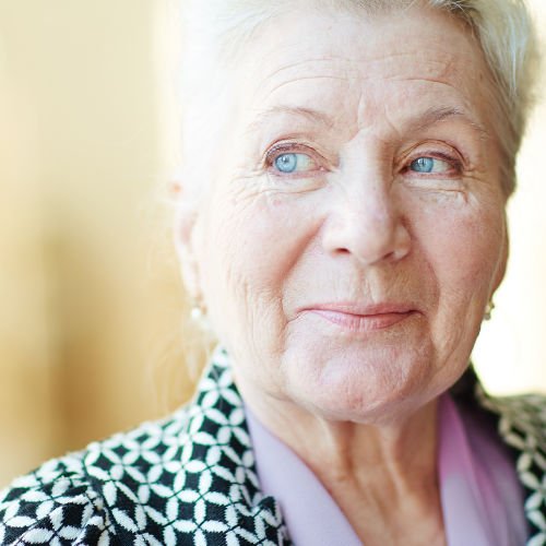 A beautiful older woman with blue eyes looking to the side