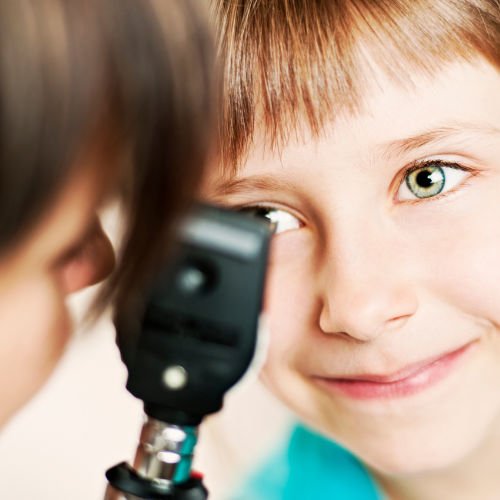 Ophthalmologist examines the eye of a child.